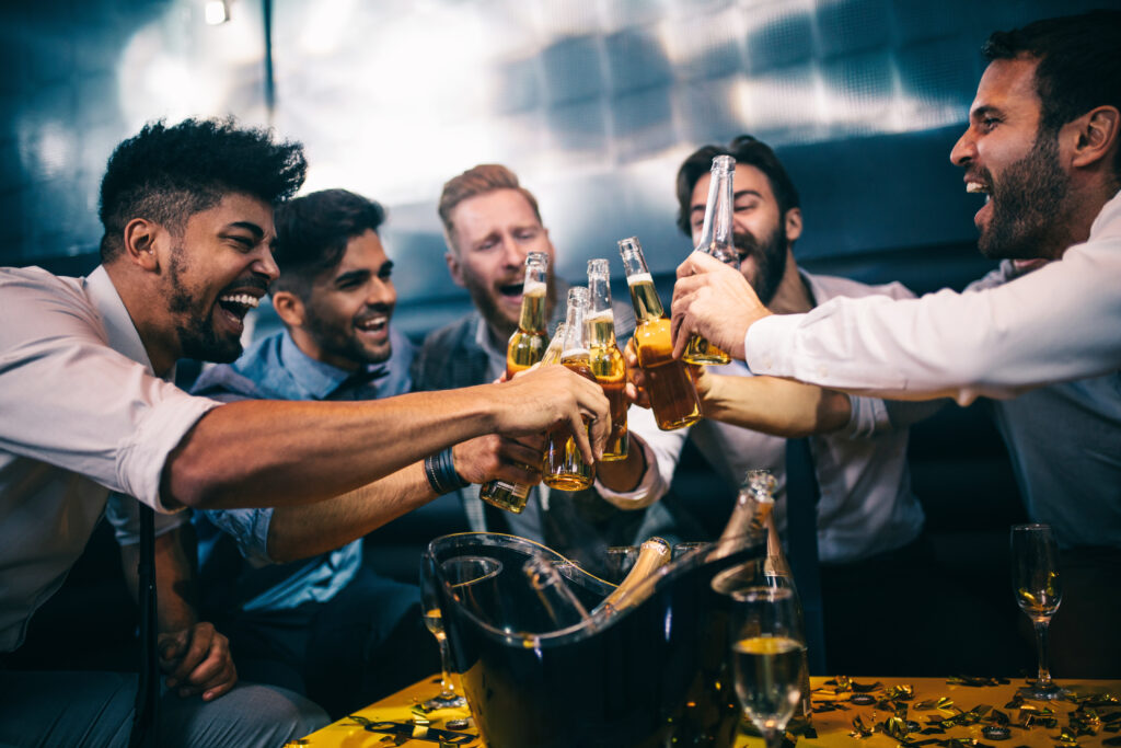 Group of young men toasting at a nightclub for a bachelor party in las vegas
