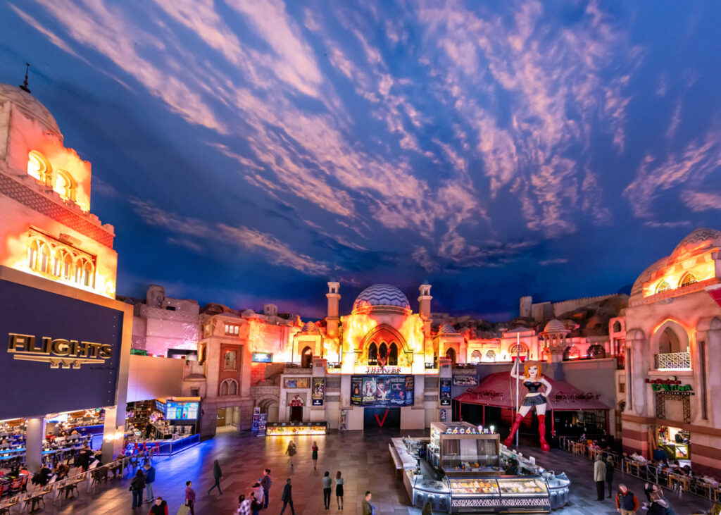 Lost City attraction inside Miracle Mile Shops with illuminated architecture and dramatic sky ceiling.